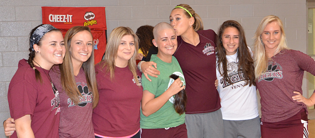 Haley Dallas, fourth from left, receives a kiss on her newly shaved head from her fellow Lady  Tiger Tennis Team member Megan Charity after Haley shaved her head at St. Baldrick's. Other tennis team members congratulating her were from left: Meg Brown, Jenna Sallee, Jade  Letheby, Anna Tumanyan and Lindy Charity. (Campbellsville University Photo by Mikayla  Smith)