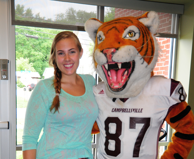 Hannah Sadler of Taylor County poses with the Tiger mascot Claws. (Campbellsville University Photo by Ellie McKinley)