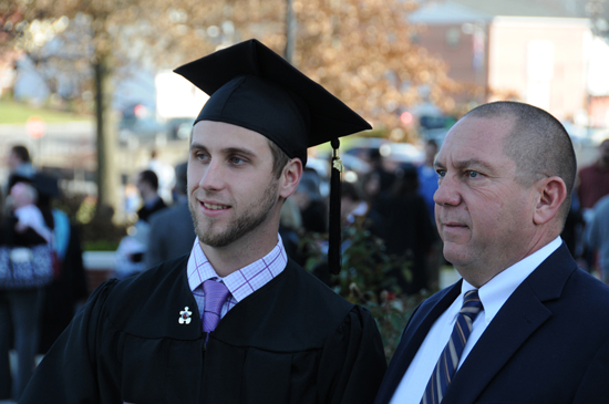 Tyler Hardy and his dad, Jim Hardy, CU assistant football coach, talk after graduation.  Hardy received a bachelor of science degree in middle graduates education/5-9. (Campbellsville University Photo by Ye Wei "Vicky")