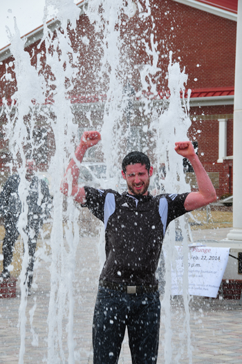 Harry Haynes cheers after surviving the cold water at  the Alumni & Friends Park fountain.