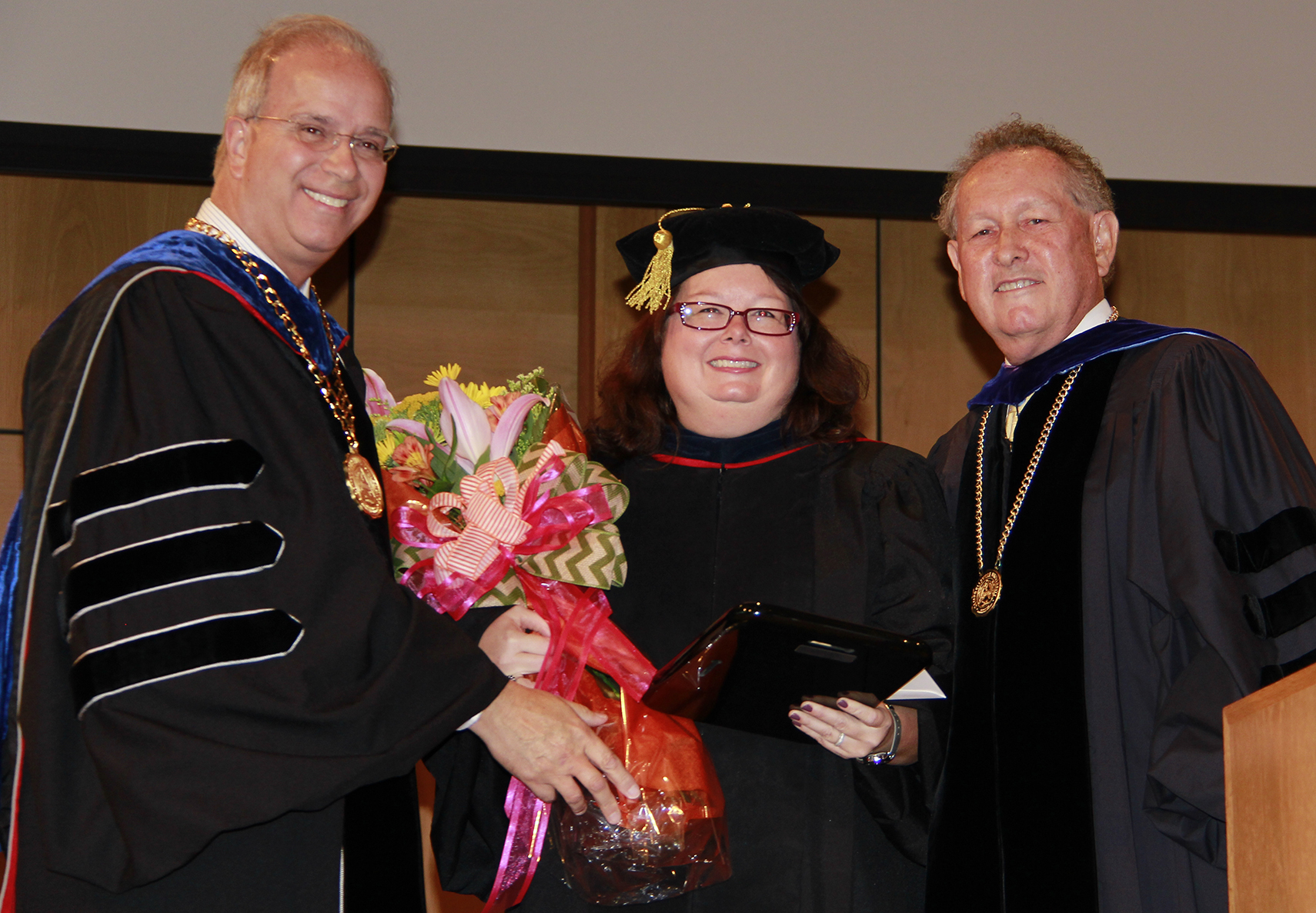 Dr. Twyla Hernandez, center, received the Non-Tentured Faculty Award from President Michael V. Carter, left, and Dr. Frank Cheatham, right, senior vice president for academic affairs. (Campbellsville University Photo by Rachel DeCoursey)