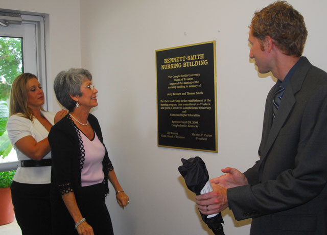 Jackie Bennett Roberts unveils one of two plaques in the Bennett-Smith Nursing Building. With her was her daughter, Jennifer; and her son, Jeff. (Campbellsville University Photo by Joan C. McKinney)