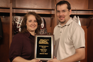 Jeannie Clark is presented her award by Chris Megginson, Campbellsville University sports information director, on the set of “Inside CU Sports.” (Campbellsville University Photo by Jim Wooley)