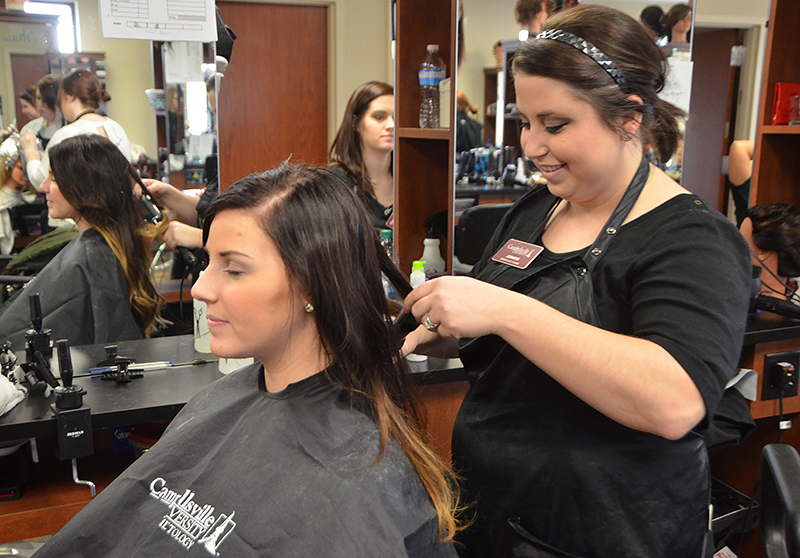 Jennifer Bland of Campbellsville works on Megan Coyle’s hair at the Cosmetology Salon of Campbell- sville University. Bland is the first student to have been all of her clinical, theory and clock hours at CU.  Coyle is from Marion County. (Campbellsville University Photo by Samantha Clark)