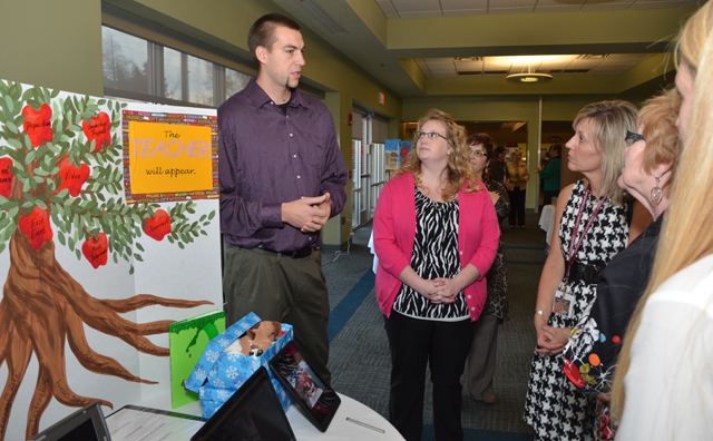 Senior Jonas Bohm, left, of Germany explains his poster to from left: Lindsey Hammons and Kristi Jenkins, NEA observer and teacher from Somerset High School, on the state NCATE team. (Campbellsville University Photo by Joan C. McKinney)