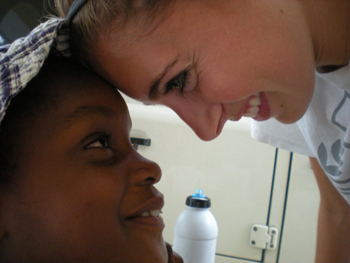 Jordan Cornett works with people in Haiti on the mission trip she and Kristi Ensminger are on