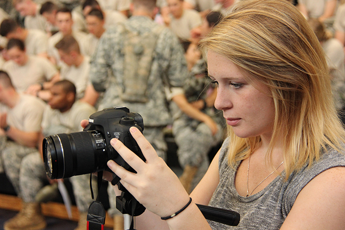 Kasey Ricketts, a Campbellsville University senior mass communication major from Jackson, Mich., checks her images during a photo session at Fort Knox, Ky. Ricketts, and four other CU students completed a 12-week internship with the U.S. Army Cadet Command, providing mass communication support to the ROTC summer camps there. (Campbellsville University Photo by Lt. Col. William Ritter)