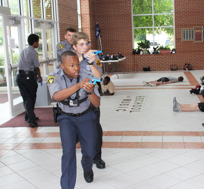 Keenan Wright from Cincinnati Police Explorers acts as a police officer in a real-life shootout simulation by Kentucky Law Enforcement Explorer Academy at Campbellsville University. (Campbellsville University Photo by Joshua Williams)