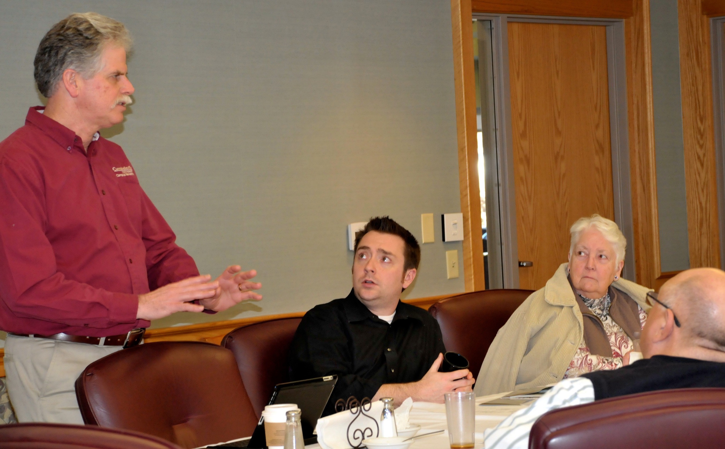 The Rev. Ed Pavy, Director, Campus  Ministries, speaks to the CU Church  Relations Council executive committee  group. Rev. Kenny Rager, Mrs. Grace  Bristow and Rev. Jay Hatfield look on.  (CU Photo by Linda Waggener)