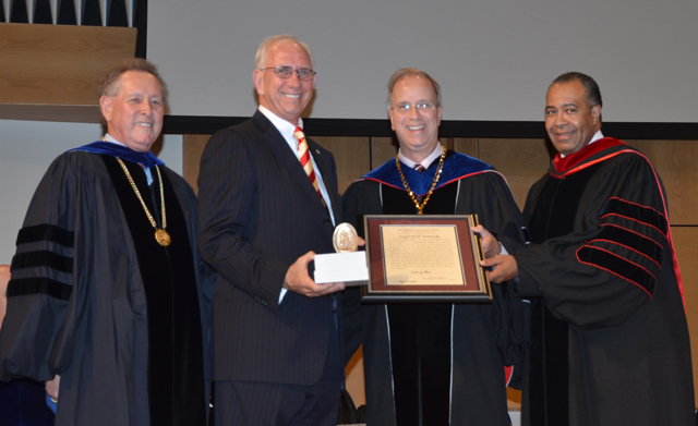 r. Larry Noe, second from left, receives the Algernon Sydney Sullivan Award at the graduate commencement from Dr. Frank Cheatham, vice president for academic affairs, left; Dr. Michael V. Carter, CU president; and Dr. Joe Owens, chair of the CU Board of Trustees. (Campbellsville University Photo by Joan C. McKinney)