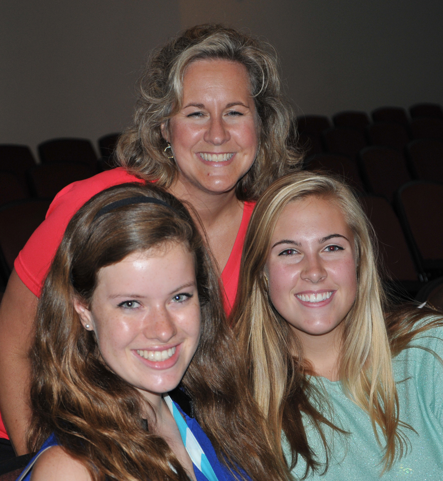 A smiling Leigh Ann Sadler, in back, takes a  moment before the Campbellsville University  Sunday night service of dedication to chat with  her daughter Hannah, right, and her new friend  Jaclyn White, from Paducah.