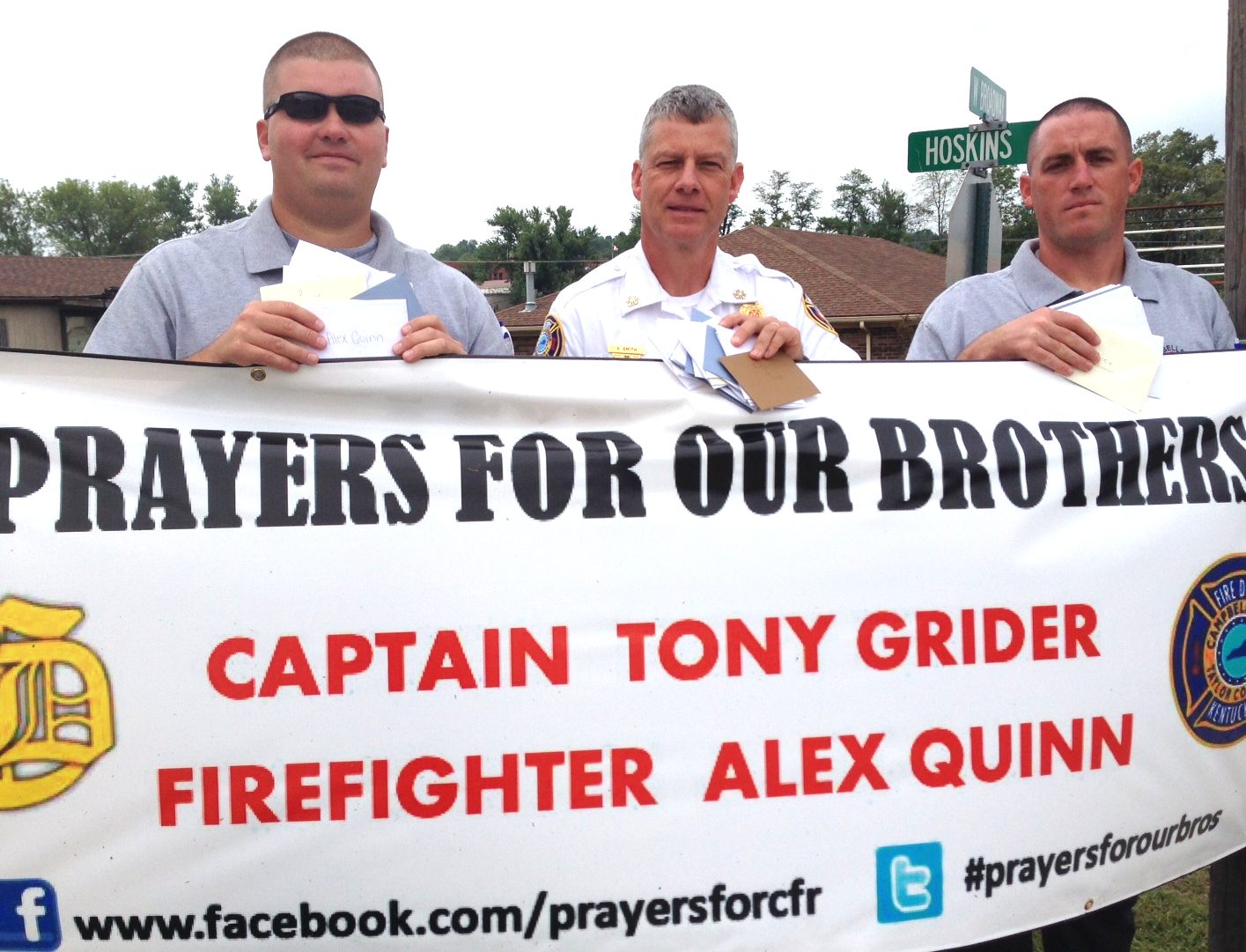  Campbellsville University Student Services hosted a card signing event for the injured firefighters so students could send their get well messages and good wishes. Above, holding a few of the cards behind the prayer request banner, are the Taylor County firemen who will take those messages to Captain Tony Grider and Alex Quinn in their evening trip to the hospital. From left are: Captain Chris Taylor, Chief Kyle Smith, and firefighter Aaron Fields. Grider and Quinn are reported to be making small positive steps with a long journey ahead of them. (Campbellsville University Photo by Linda Waggener) 