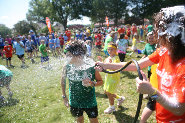 Ashley Chesnut, assistant director of CentriKid 7 from Birmingham, Ala., sprays Lindsey Isbell of Savannah, Tenn. This year is Isbell's first year at CentriKid. (Campbellsville University Photo by Andre Tomaz)