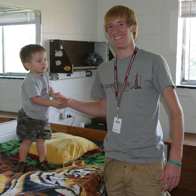 Jeremy Litton, right, of Somerset, Ky., and his nephew Isaiah hang out in the residence hall while moving in at Campbellsville  University. Isaiah is the son of Grant (Jeremy’s brother) and Jayne Litton, both 2009 graduates of CU. (Campbellsville  University Photo by Gerry James)