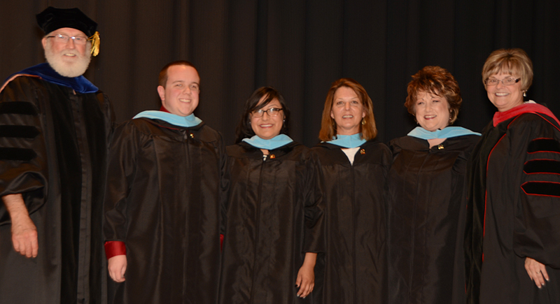 Dr. Kellie Cody, assistant professor of social work, and Dr. Darlene Eastridge, dean of the Carver School of Social Work and Counseling, pinned and hooding the Master’s of Science in Counseling. From left – Cody, Cole Torbert, Daisy Perez, Lisa Nugent, Sharon Arflin and Eastridge. (Campbellsville University Photo by Drew Tucker)
