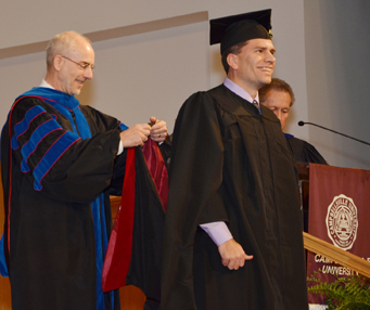 Matt Flanagan of Bardstown, Ky., son of Dan and Ginny Flanagan of Campbellsville, is hooded by Dr. John Hurtgen, dean of the School of Theology, as he receives his master of theology degree. (Campbellsville University Photo by Joan C. McKinney