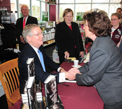 Above, Barry Bertram, a member of the CU Board of Trustees, talks with U.S. Sen. Mitch McConnell after the reception in McConnell's honor. Campbellsville Mayor Brenda Allen, in picture above at left, gets U.S. Sen. Mitch McConnell's autograph. McConnell addressed a crowd in the Winters Dining Hall. Kyle Davis, director of campus safety, was one of those having their picture made with McConnell. (Campbellsville University Photos by Joan C. McKinney)