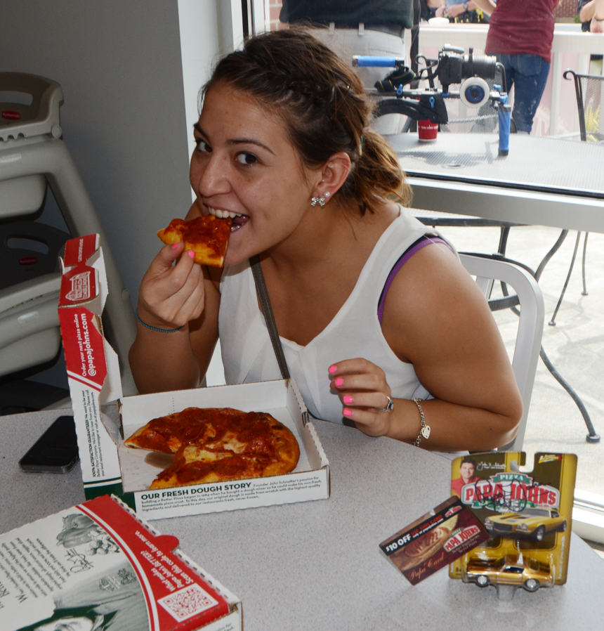 CU student Michelle Lomas enjoys some of the free pizza offered by Papa John's during the grand opening. (Campbellsville University Photo by Hanna Hall)