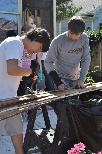   Tomohiro Suko, a senior from Japan, works on a home in New Orleans with Trent Creason, campus ministries intern. (Photo by Sarah Creason)