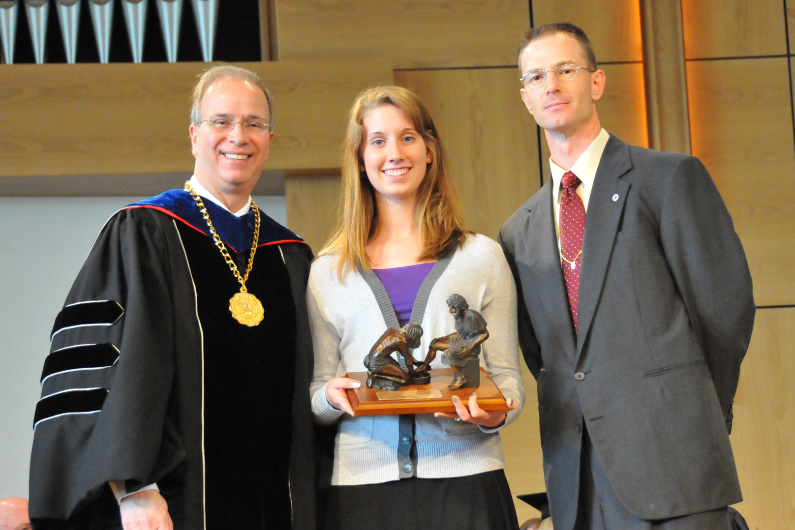 Olivia Brainard of Somerset, Ky. receives the Servant Leadership Award from Campbellsville University president Michael V. Carter, left, and Josh Anderson, dean of student services, at Honors and Awards Day. (Campbellsville University Photo by Munkh-Amgalan Galsanjamts)