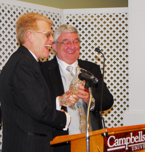 Larry Blanton, a 1969 graduate of Campbellsville University, right, receives the Advancement Board Distinguished Service Award given by Advancement Board member Steve Horner, a 1965 graduate of CU. (CU photo by Joan C. McKinney)