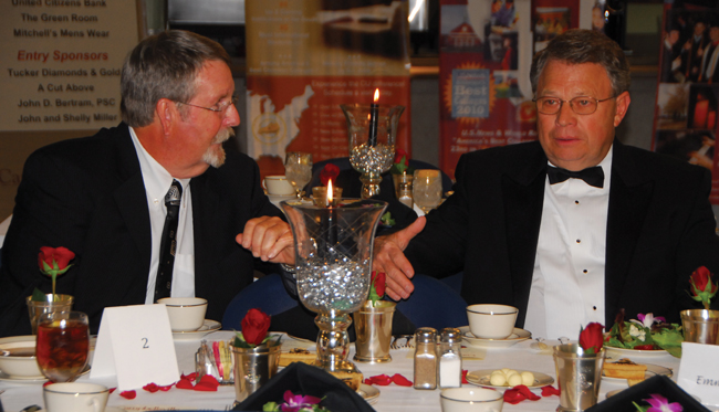 Journalist Byron Crawford, right, talks with David Revis, husband of Emma Revis, director of foundation relations, at the Campbellsville University Derby Rose Gala. (CU photo by Joan C. McKinney)