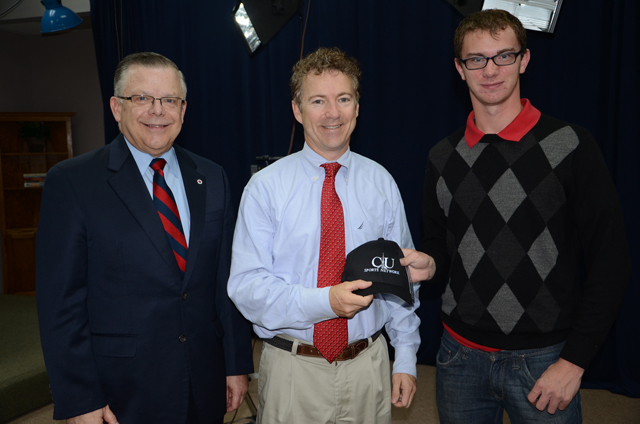 United States Senator Rand Paul, center, (R-Ky.), receives a Campbellsville University Sports Networkcap from Austin Yates, a sophomore from Campbellsville. At left is John Chowning, host of "Dialogue on Public Issues," who interviewed Paul for WLCU TV. (Campbellsville University Photo by Naranchuluu Amarsanaa)