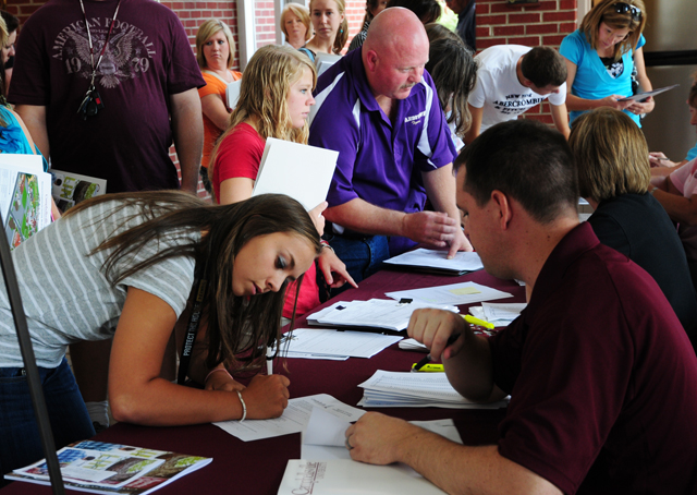 Raven Burress, 465 Pepper Road, Campbellsville, signs up at LINC at Campbellsville University with help from Scott Necesssary, director of dual credit/assistant to the vice president for admissions. (Campbellsville University Photo by Ellie McKinley)