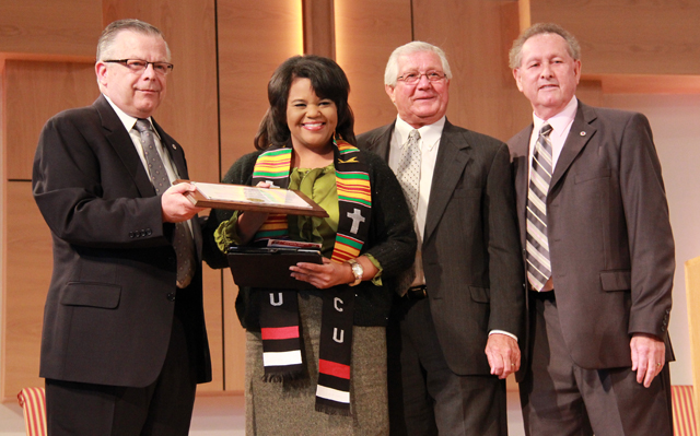 Renee Shaw, left, producer, writer and host of Kentucky Education Television’s “Connections with Renee Shaw,” receives the Kente Cloth from, from left: John Chowning, vice president for church and external relations and executive assistant to the president; Dr. Frank Cheatham, senior vice president for academic affairs; and Taylor County Judge/Executive Eddie Rogers. (Campbellsville University Photo by Rachel DeCoursey)