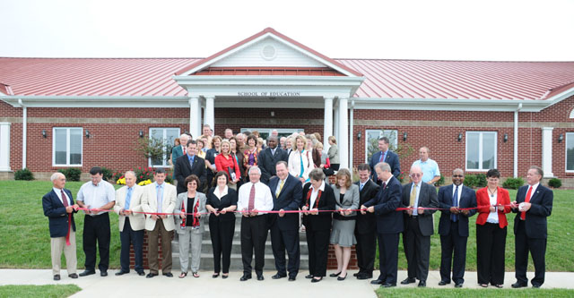 Cutting the ribbon at the dedication of the School of Education building dedication were from left: Paul Osborne, chair of the CU Board of Trustees’ building and grounds committee; Mark Carney, Taylor County clerk; Kenneth Koehler, architect; Fred Hilpp; Campbellsville Mayor Brenda Allen; Janet Clark, retired teacher, Taylor County Elementary School; Taylor County Judge/Executive Eddie Rogers; Dr. Phil Rogers, executive director, Education Professional Standards Board; Dr. Brenda Priddy, dean of the School of Education; Ashley Greer, senior from Eubank, Ky.; Dr. Joel Carwile, pastor of Valley View Church, Louisville, Ky.; Dr. Michael V. Carter, CU president; Jim Achterhof with Richard D. Van Lunen Foundation; Michael Dailey, director, Division of Educator Quality and Diversity, Kentucky Department of Education; Dr. Carol Garrison, professor of education; and Dr. Frank Cheatham, vice president for academic affairs. (Campbellsville University Photo by Andre Tomaz)