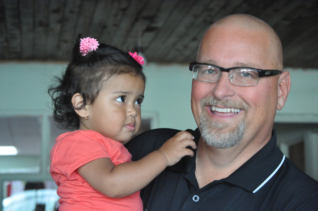Rusty Hollingsworth, director of athletics at Campbellsville University, holds a child in Costa Rica on the recent coaches mission trip.