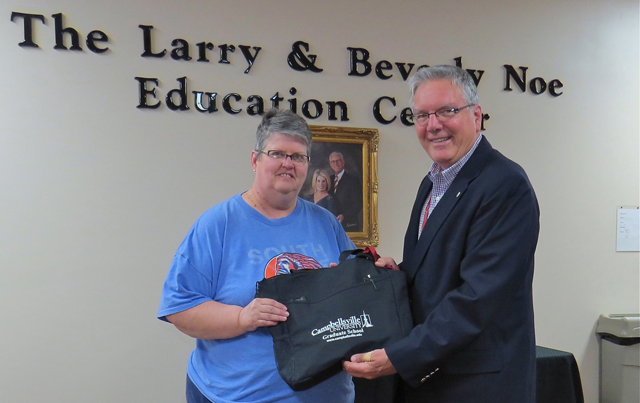 Dr. H. Keith Spears, right, presents a CU Somerset bag and supplies to Karen Smith. 