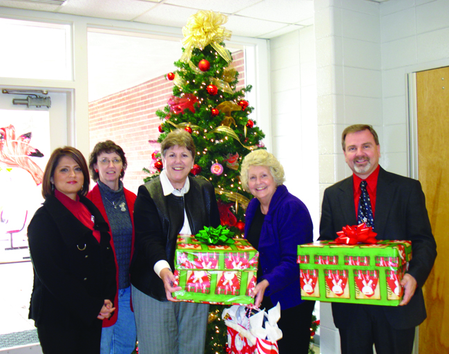 Campbellsville University’s School of Education personnel presented school supplies to Taylor County Middle School Dec. 17 in lieu of exchanging Christmas gifts among themselves. From left are: Sarah Jeffrey, Alice Steele and Dr. Brenda Priddy, from the CU School of Education; and Cherry Harvey and Tony Jewel from Taylor County Middle School. (Campbellsville University Photo by Gwen Sampson)