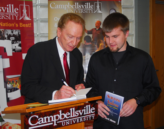 Sean Stengl, right, of LaGrange, Ky., has his book signed by Dr. Don Mathis, president of the Kentucky Baptist Convention. Stengl, of Westport Road Baptist Church in Louisville, credits Dr. Chip Pendleton, pastor of Westport Road Baptist Church, as his mentor. (Campbellsville University Photo by Joan C. McKinney)