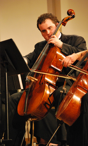Seth Johnson plays cello during a University  Orchestra concert. He has composed music  played by the orchestra. (Campbellsville  University Photo by Munkh-Amgalan Galsanjamts)