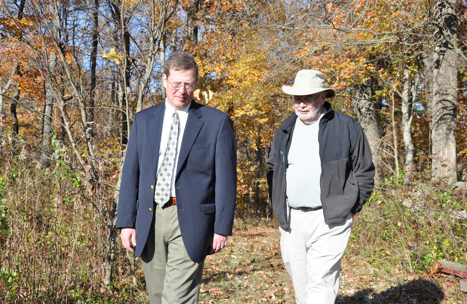 Dr. Matthew Sleeth, left, walked in Clay Hill Memorial Forest with Dr. Gordon Weddle, director of the forest. (Campbellsville University Photo by Bayarmagnai "Max" Nergui)