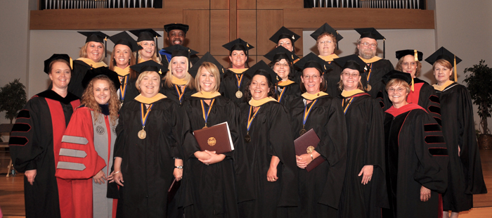 Members of the first master of social work graduates from the Carver School of Social Work and Counseling at Campbellsville University include from left, with their professors: Front row – Dr. Candace Hansford, assistant professor of social work; Ann Cook Adcock, Lesley Renee Smith Newton, Shannon L. Ryan Nottingham, Gloria Jean Greynolds; Baerette Leeann Bishop Daniel and Dr. Darlene Eastridge, dean of the Carver School of Social Work and Counseling. Second row – Dr. Michelle Tucker, assistant professor of social work; Juliana Marie Brown, Phoebe Ann Dewar-Williams and Nancy Danelle Draper Coomer. Back row – Tracy Monique Murray, Kristina Lynn Cooper, Dr. Japheth Jaoko, assistant professor of social work; Misty Renee Curry, Aimee Renee Morris, Patricia Ann Scott; Tony Michael Rutherford; Dr. Helen Mudd, associate professor of social work; and Debbie Carter, assistant professor of social work. (Campbellsville University Photo by Bayarmagnai “Max” Nergui)