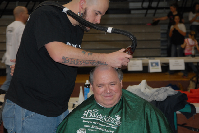 Stan McKinney, assistant professor of journalism, has his head shaved by Matthew Rogers of Disco Chop Shop at last year's St. Baldrick's event. (Campbellsville University Photo by Andre Tomaz)