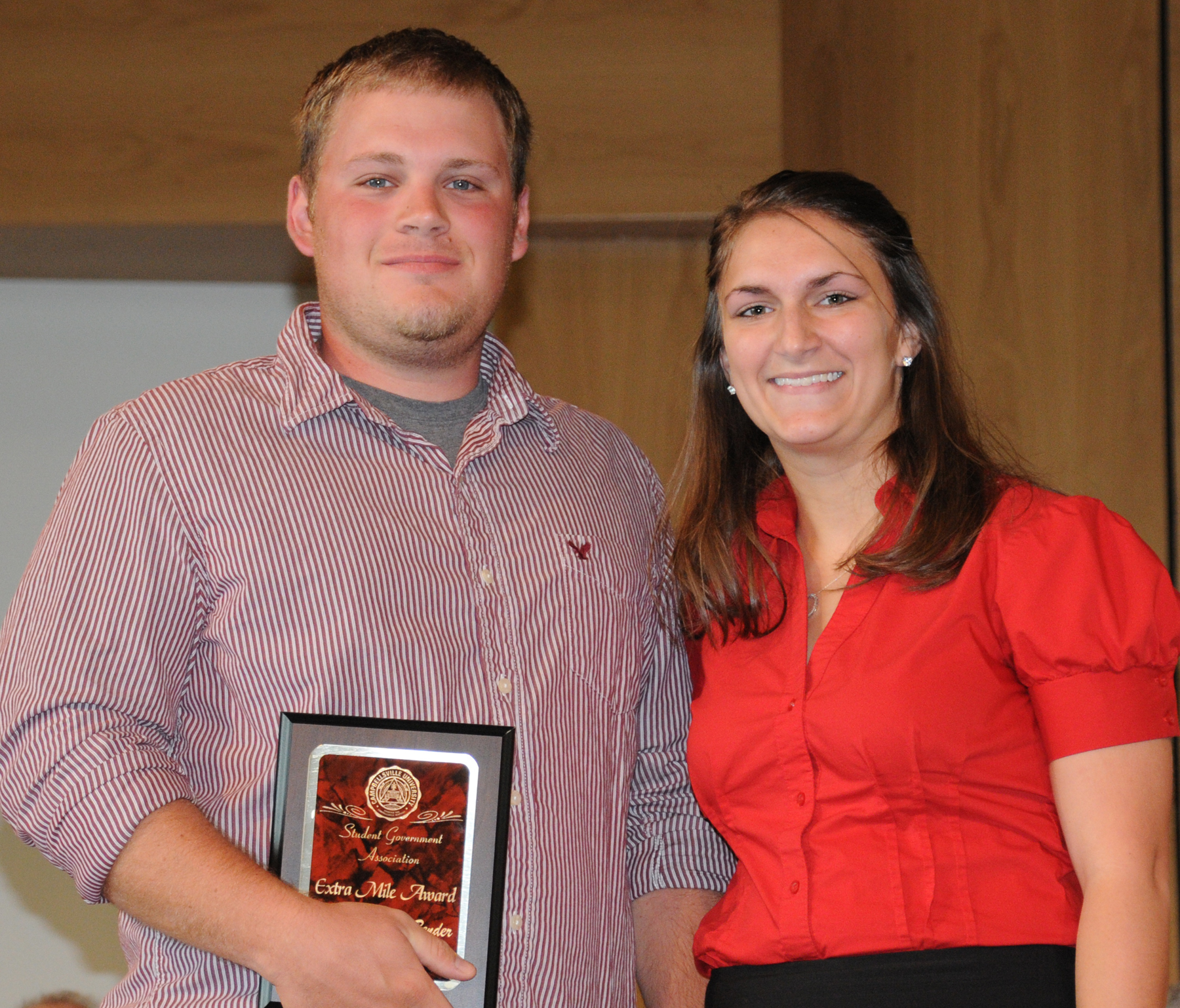 Robert Bender receives the SGA Student Extra Mile Award from Christina Miller, SGA president. (CU Photo by Ashley Zsedenyi)