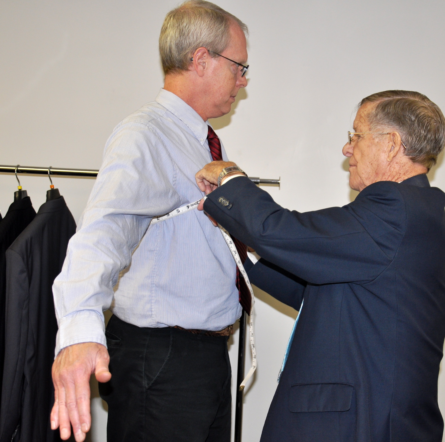 Jim Tatum with "Suits for Servants," right, fits Dr. Chris Conver, recruitment counselor and adjunct faculty member at Campbellsville University-Louisville, for a suit. (Campbellsville University Photo by Bayarmagnai "Max" Nergui)