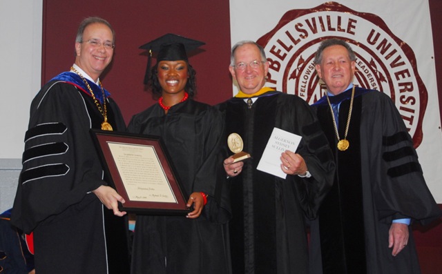 Shajuana Ditto of Brandenburg, Ky., second from left, receives the student Algernon Sydney Sullivan Award at Campbellsville University's undergraduate commencement. Making the presentation were from left: Dr. Michael V. Carter, president; Dr. Jay Conner, chair of the CU Board of Trustees; and Dr. Frank Cheatham, vice president for academic affairs. (Campbellsville University Photo by Joan C. McKinney)