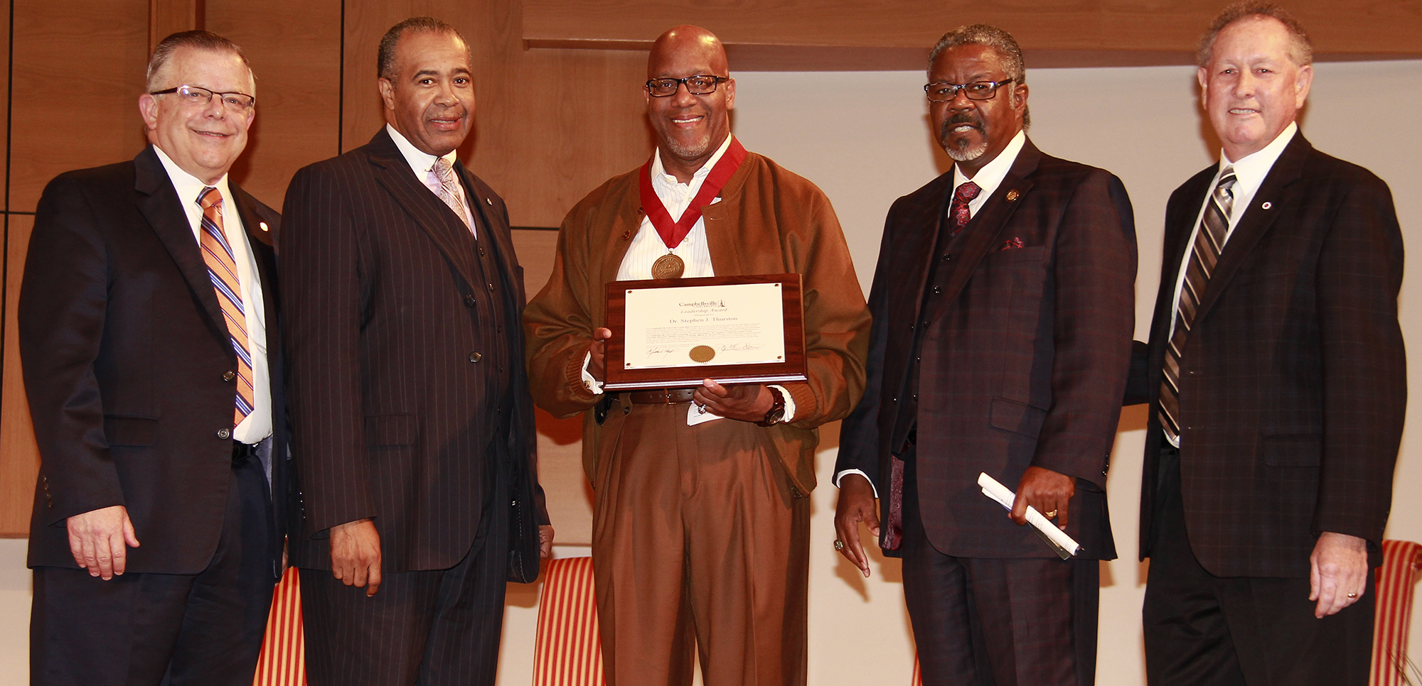 Dr. Stephen J. Thurston, third from left, senior pastor of New Covenant Missionary Baptist Church in Chicago, Ill. receives Campbellsville Universities Leadership Award during a weekly Chapel service that he spoke at. Presenting the award is, from left: Dr. John Chowning, vice president of Church and External Relations and executive assistant to the president; Dr. Joseph Owens, chair of CU's Board of Trustees; Thurston; Dr. C.B. Akins, pastor of First Baptist Church Bracktown in Lexington, Ky. and moderator of the General Association of Baptists in Kentucky; and Dr. Frank Cheatham, senior vice president of Academic Affairs. (Campbellsville University Photo by Rachel DeCoursey)