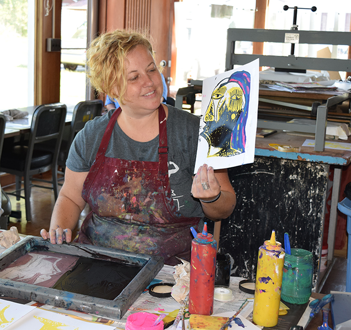 Tori Christgen demonstrates the art of printmaking at the Susan Kirkland Tesseneer Art Studio. Her exhibit is at the Pence-Chowning Art Gallery through Oct. 2. (Campbellsville University Photo by Jesse Harp)