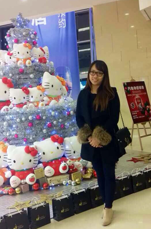 Ye Wei "Vicky" of China stands beside a  Hello Kitty Christmas tree in China. Hello  Kitty is popular in China. (Photo by Shuhua  Liu)