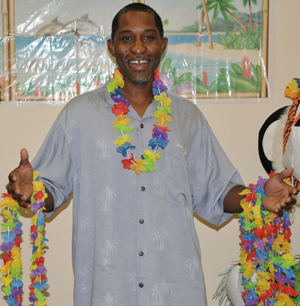  Victor Vinson, a master of theology student  and a 2010 graduate, welcomes those attending the luau with leis. (Campbellsville University  Photo by Linda Waggener)