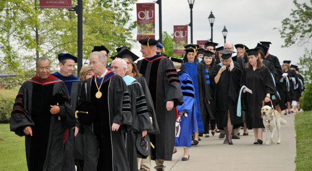 Dr. Joseph Owens, left, chair of the CU Board of Trustees, and Dr. Michael V. Carter, president of Campbellsville University, lead graduate students to commencement. (Campbellsville University Photo by Linda Waggener)