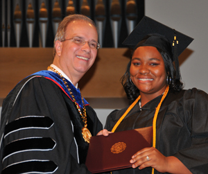 Whitney Vaughn of Canmer, Ky., receives her elementary education/P-5 degree from Camp- bellsville University President Michael V.  Carter. (Campbellsville University Photo by Christina Kern)