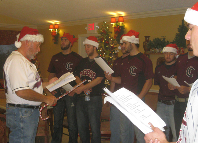Beauford Sanders, left, head coach of the Campbellsville University baseball team, gets his players in the Christmas spirit as they sing Christmas carols to residents of the Grand View Nursing & Rehabilitation Facility. The Tiger baseball team took a break from studying for finals and spent the afternoon Dec. 8 singing Christmas carols and visiting with residents. (Photo courtesy of Barbara Sanders)