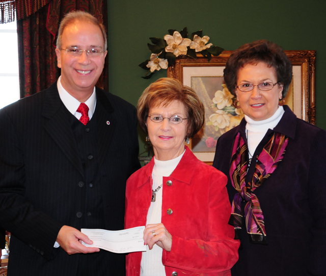 Joyce Durham and Pat Stotts, members of Columbia Baptist Church, present a check to Dr. Michael V. Carter, president of Campbellsville University, for $3,500 to cover postage to ship Operation Christmas Child boxes collected from Campbellsville University. (Campbellsville University Photo by Christina Miller)