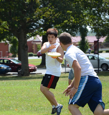 Changsik Choi, left, a junior from Korea, catches a frisbee from Adam Smith. (Campbellsville University  Photo by Christina Kern)
